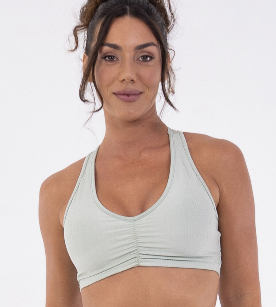 Top fitness verde Aloe com costas nadador, franzido central e bojos removíveis.